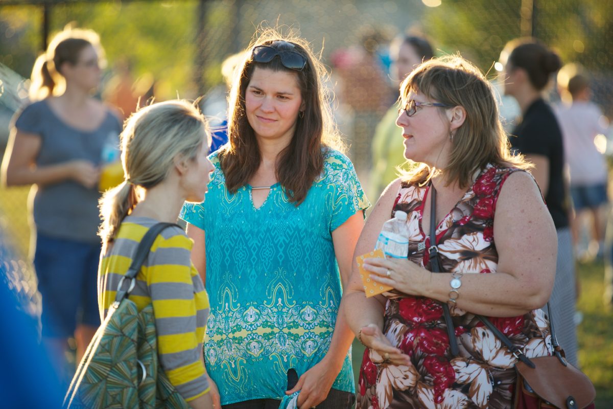 Trinity parents chatting at a school BBQ