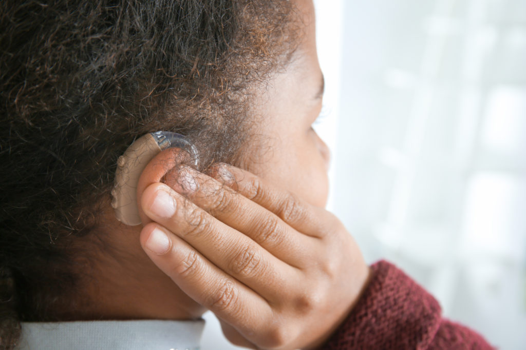 Little girl with hearing aid, closeup