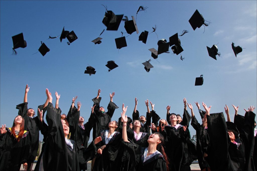Graduating class throwing hats