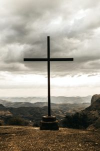 cross overlooking a mountain range