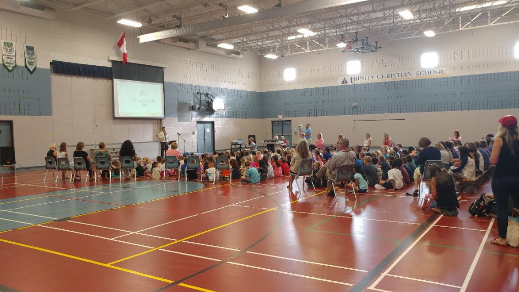 photo of students and teachers in assembly