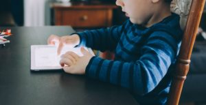 Small child looking at tablet.