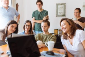 people gathered around laptop