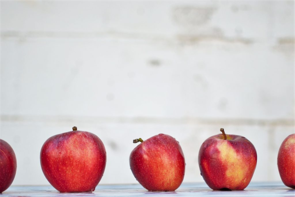 Apples lined up against a white background.