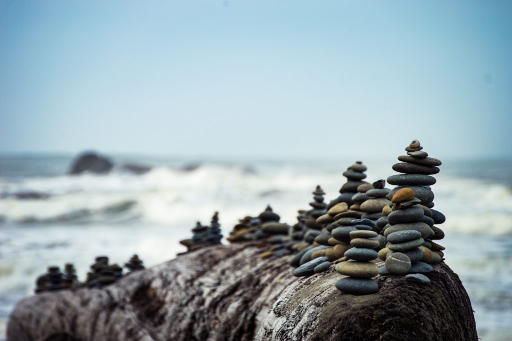 Stones carefully stacked by the ocean.