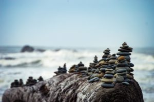 Stones carefully stacked by the ocean.