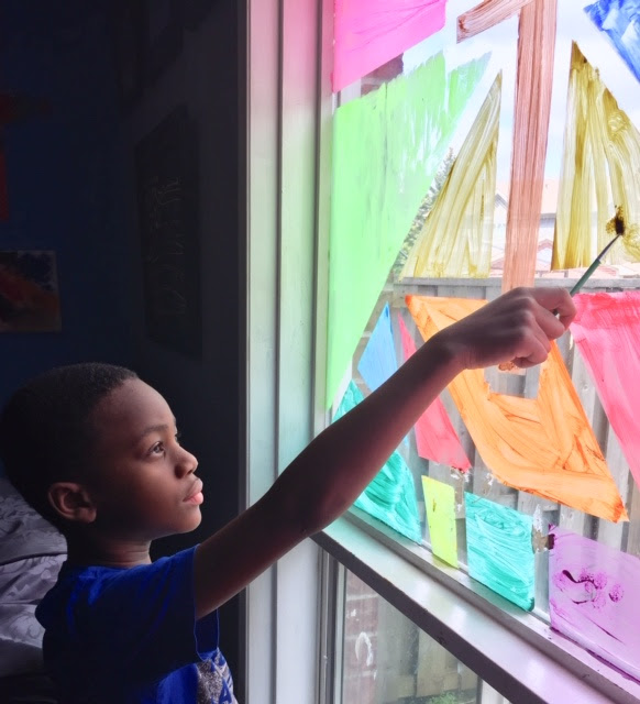 kid painting a window