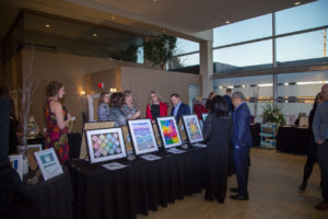 people looking at art at the 2nd trinity gala